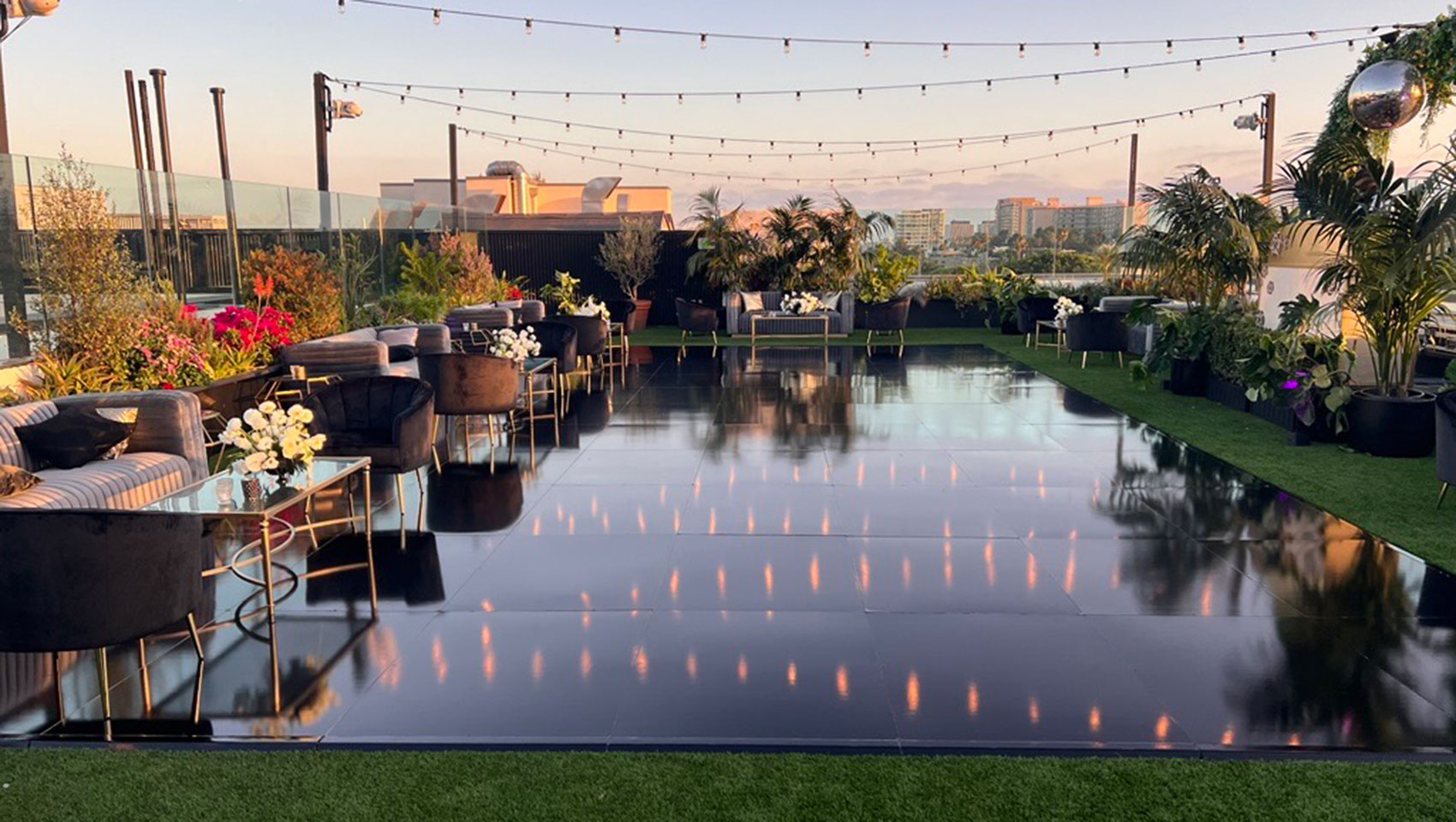 La Peer rooftop set up for wedding with string lights and dance floor
