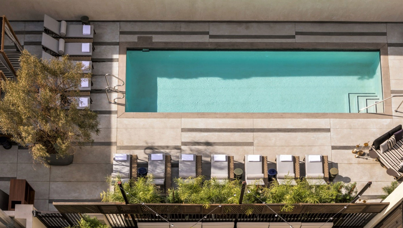 Aerial view of La Peer pool with chairs and umbrellas