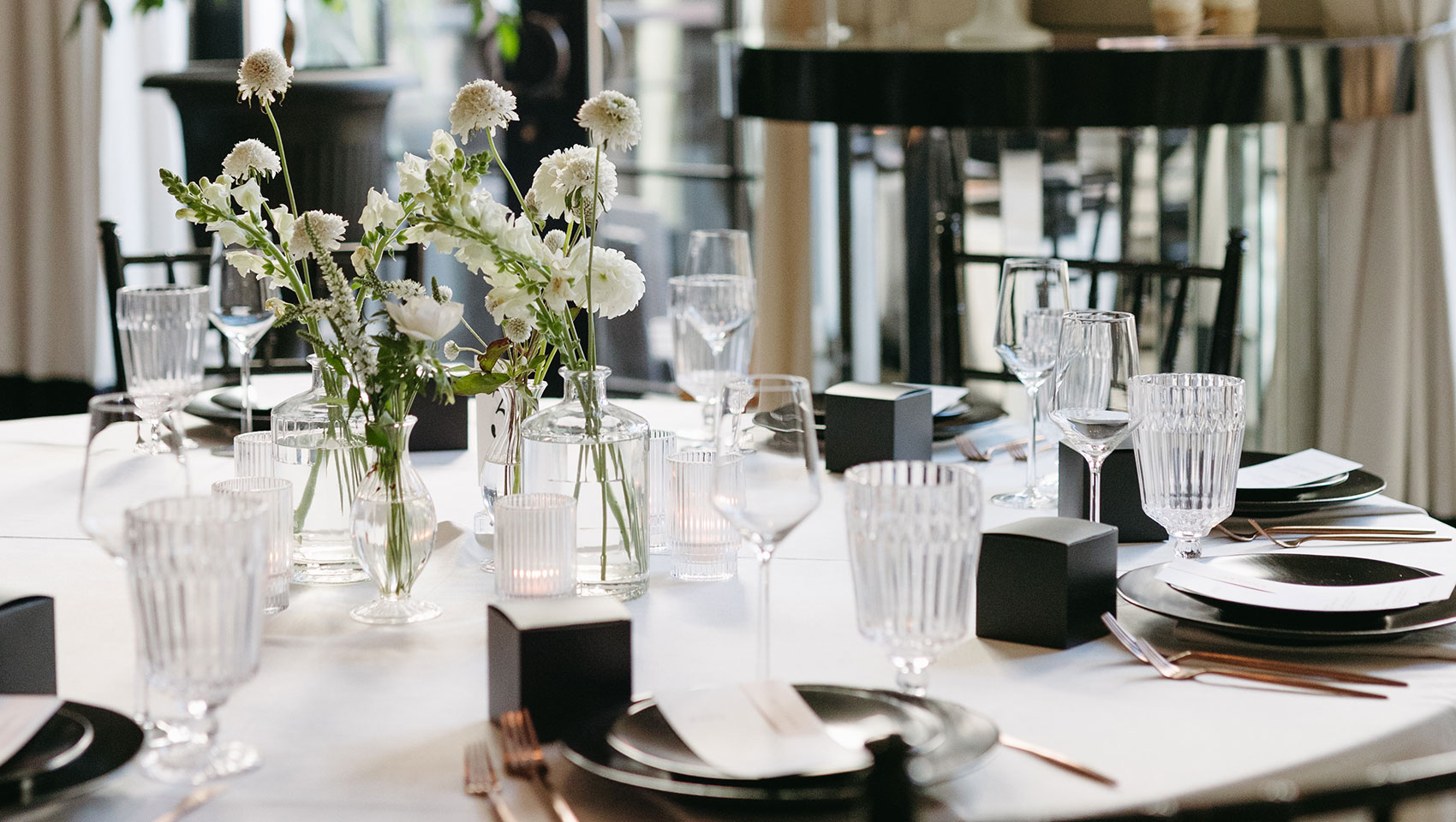 La Peer wedding tablescape with wedding cake in the background