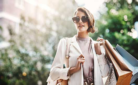 woman in sunglasses with shopping bags